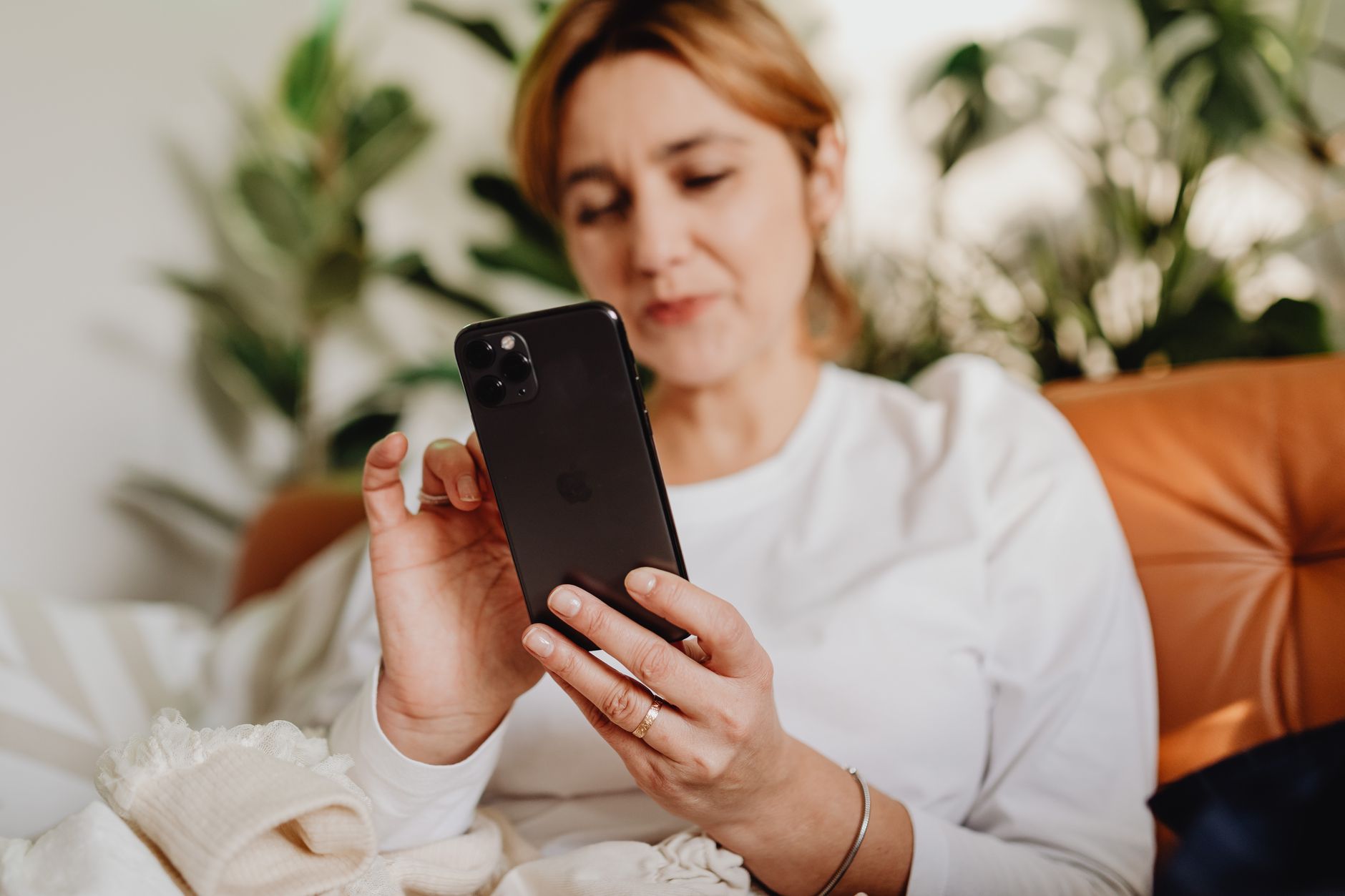 スマートフォンでメッセージを確認している女性のイメージ